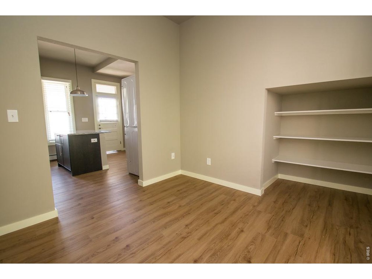 1806 17th Street Boulder, CO 80302 - Photo 15 of 45 a view of an empty room with wooden floor and a window