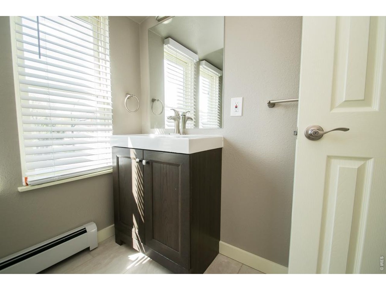 1806 17th Street Boulder, CO 80302 - Photo 28 of 45 a bathroom with a sink a window and a mirror