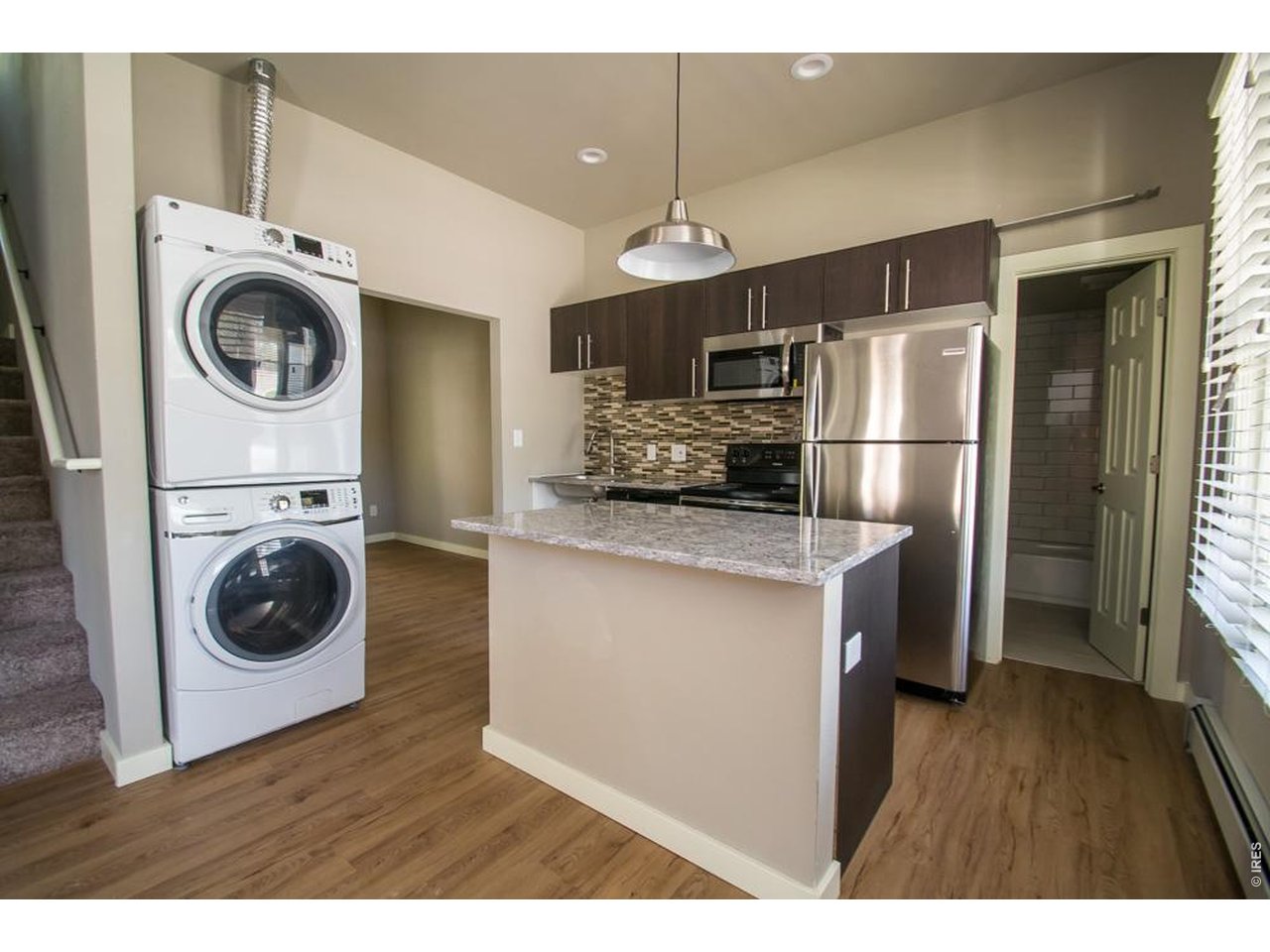 1806 17th Street Boulder, CO 80302 - Photo 6 of 45 a kitchen with a refrigerator a washer and dryer