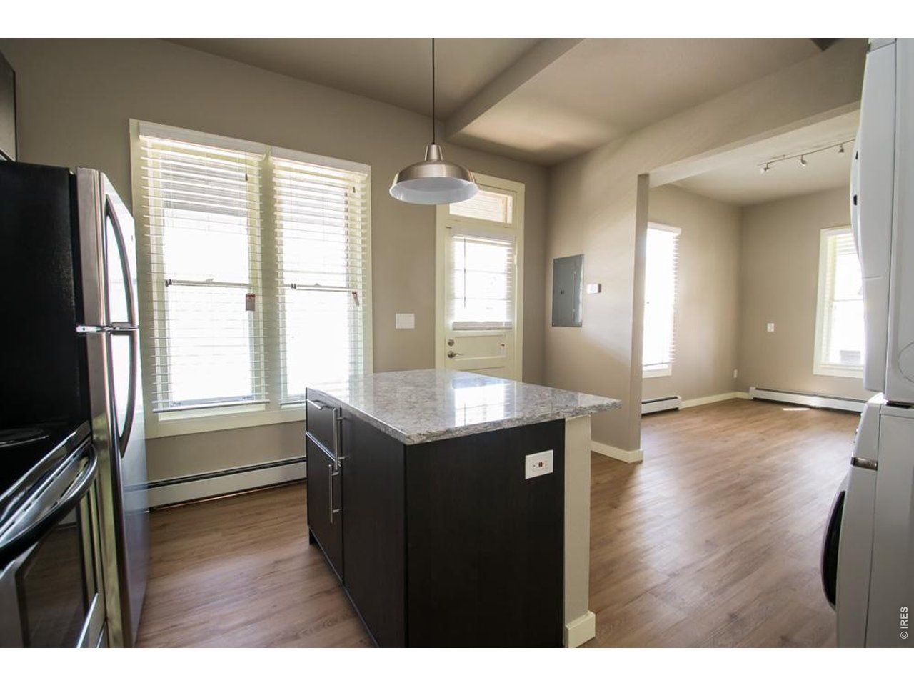 1806 17th Street Boulder, CO 80302 - Photo 7 of 45 a kitchen with granite countertop a stove and a wooden floor