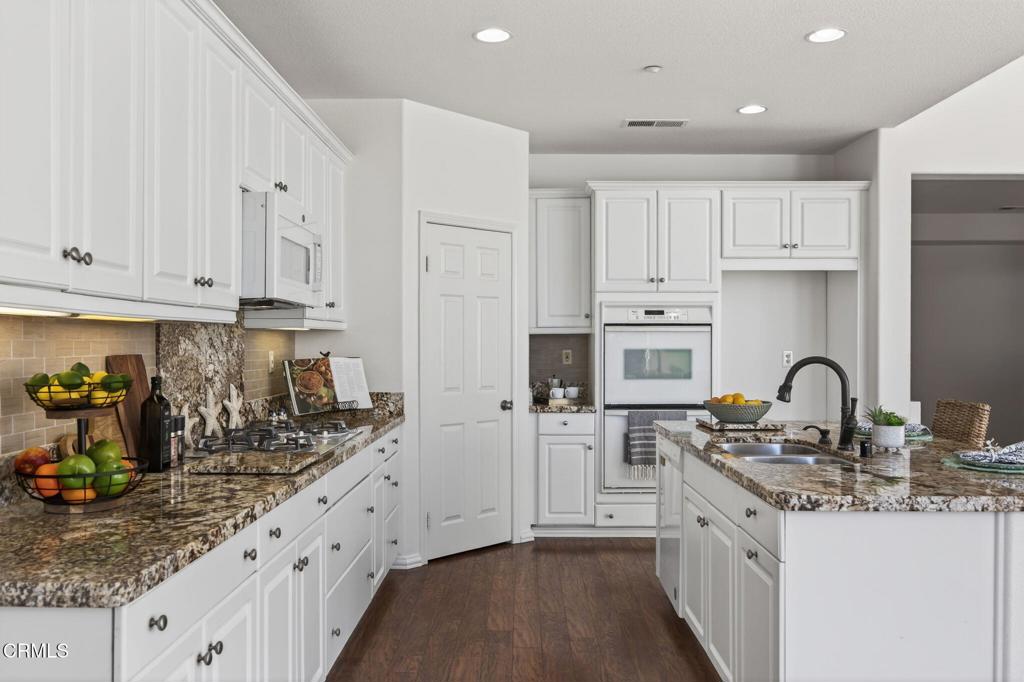 2914 Naples Drive Oxnard, CA 93035 - Photo 14 of 51 a kitchen with stainless steel appliances granite countertop a refrigerator sink and white cabinets