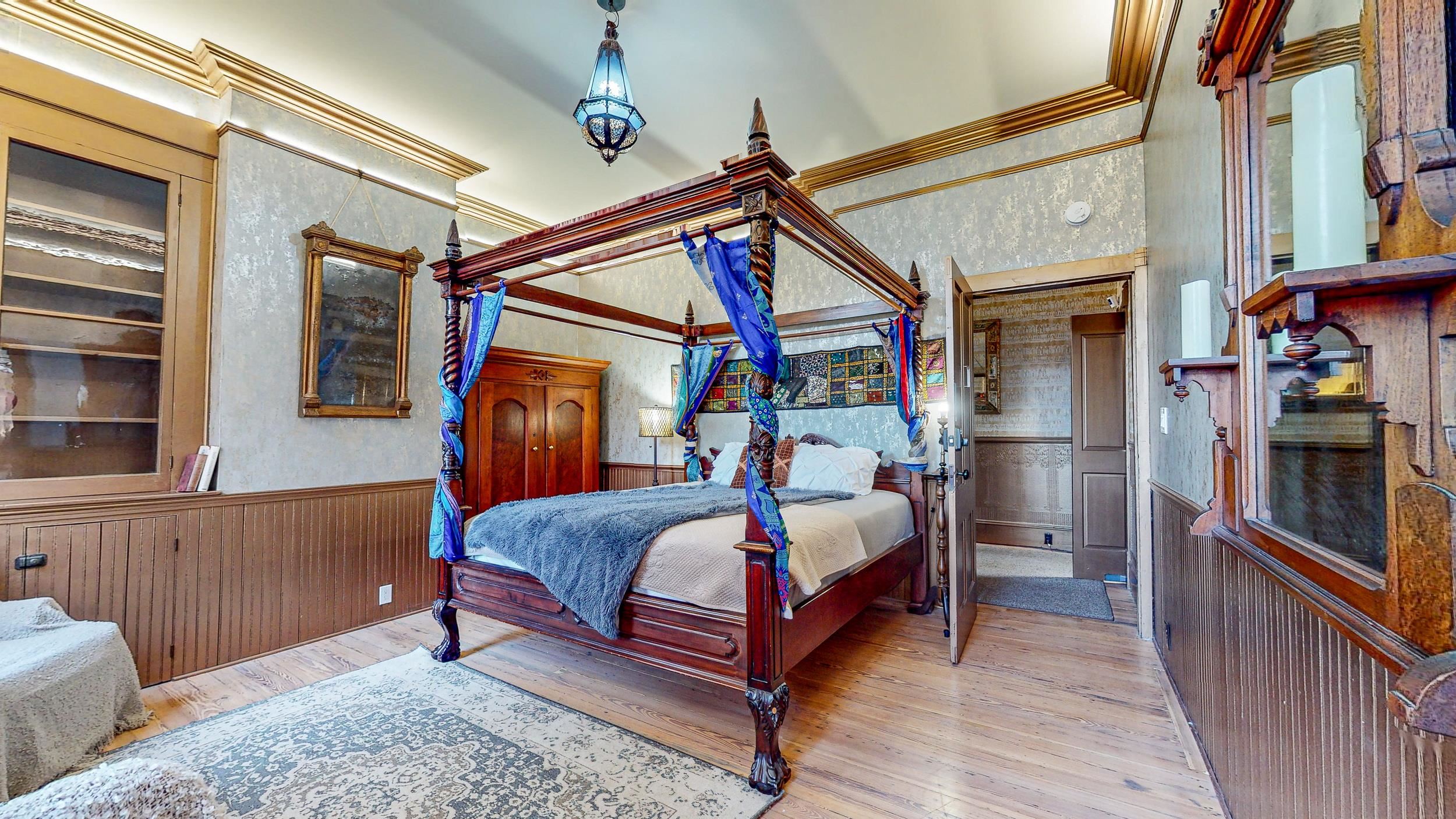 63 Orange Street St. Augustine, FL 32084 - Photo 13 of 74 a bedroom with a bed and a mirror