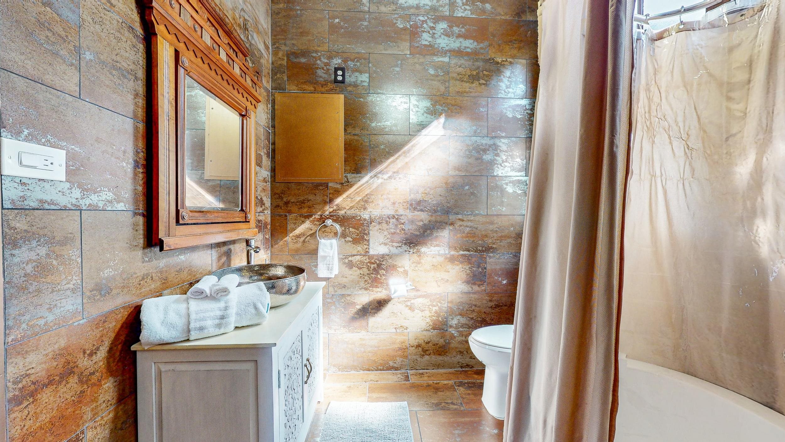 63 Orange Street St. Augustine, FL 32084 - Photo 18 of 74 a bathroom with a granite countertop shower a sink and a toilet