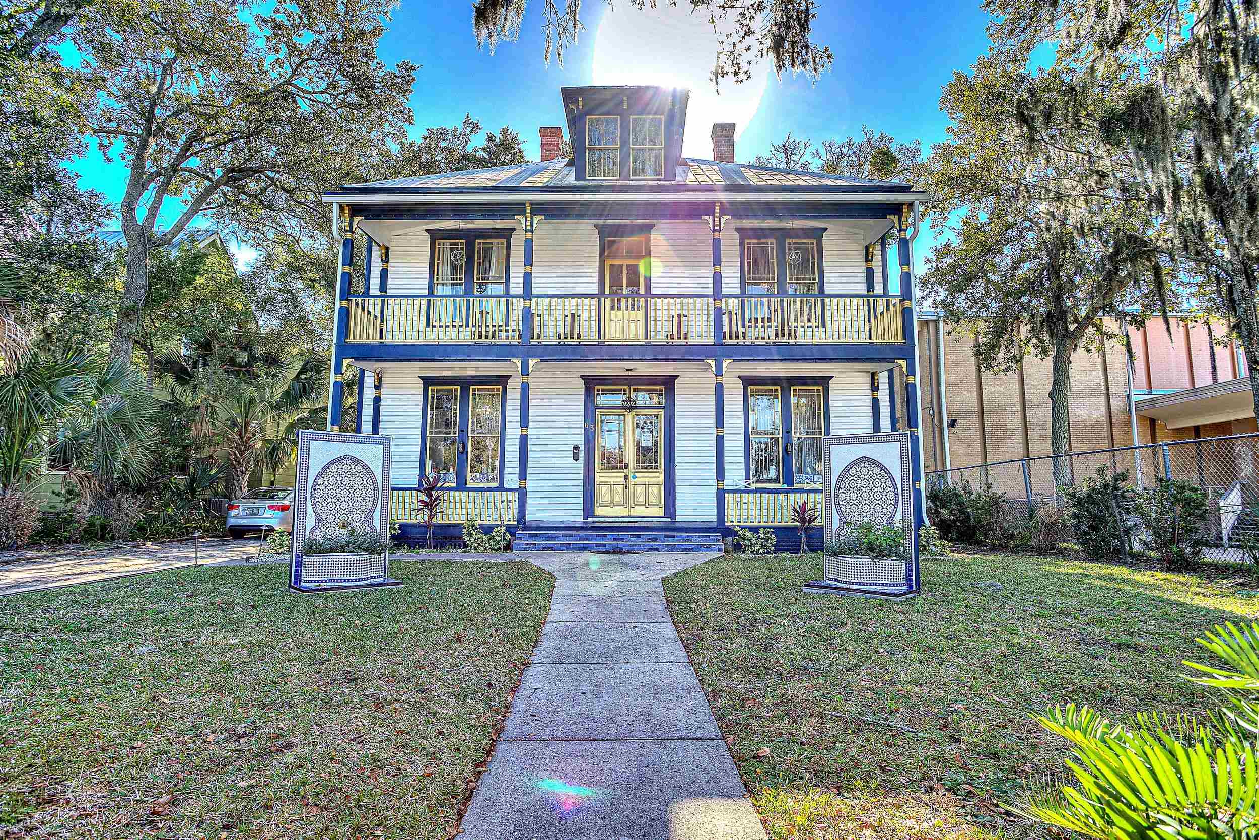 63 Orange Street St. Augustine, FL 32084 - Photo 3 of 74 a front view of a house with garden and yard
