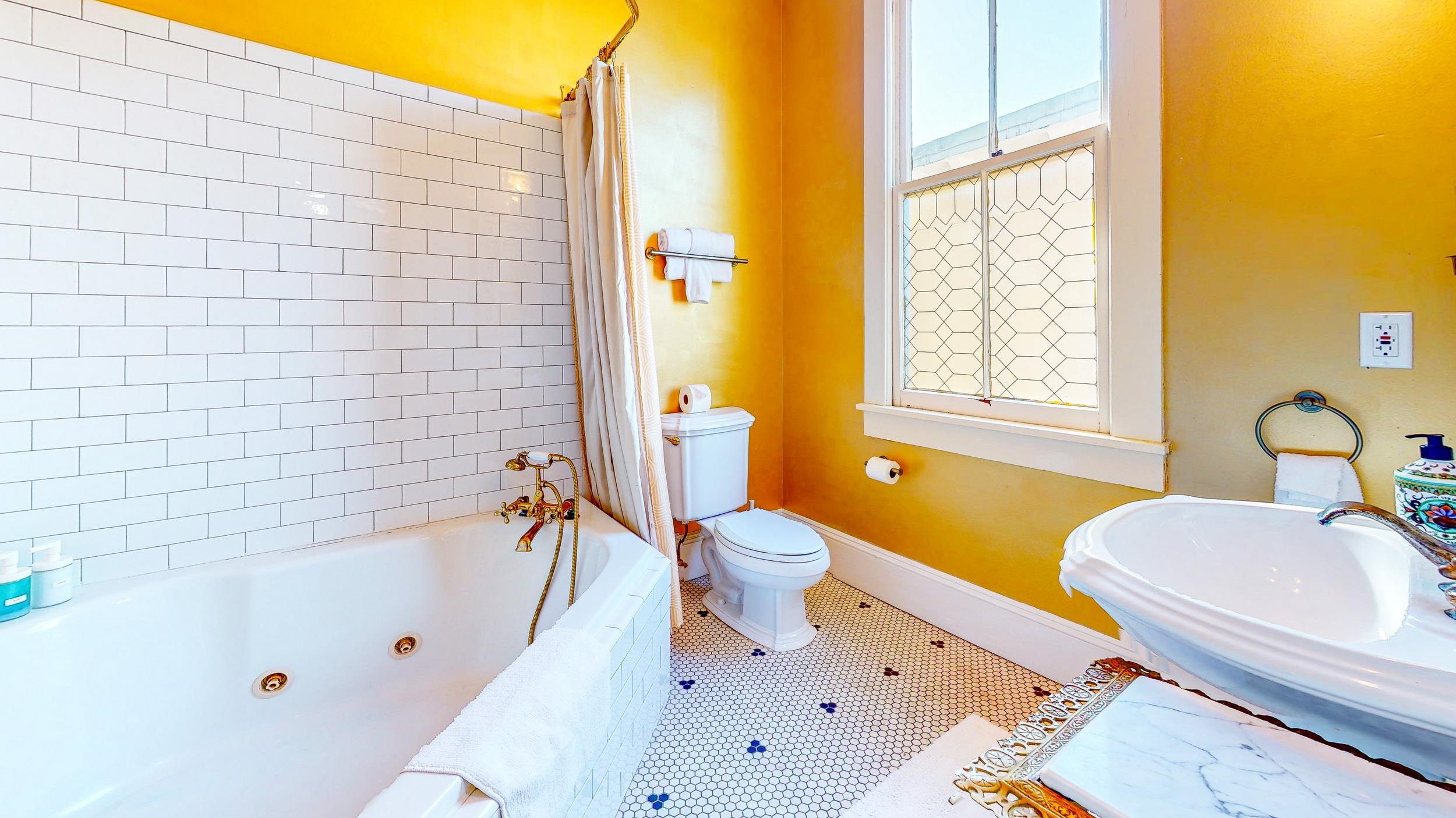63 Orange Street St. Augustine, FL 32084 - Photo 36 of 74 a bathroom with a sink a bathtub and a shower