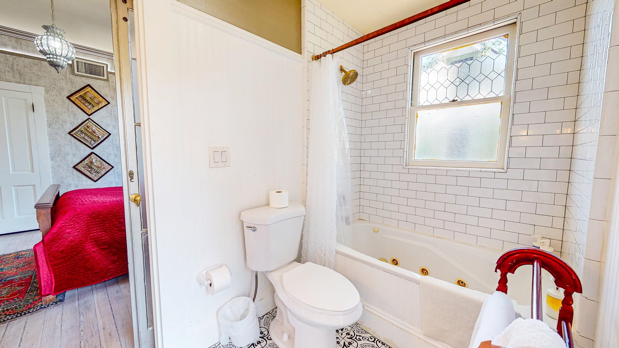 63 Orange Street St. Augustine, FL 32084 - Photo 40 of 74 a bathroom with a toilet and a bathtub