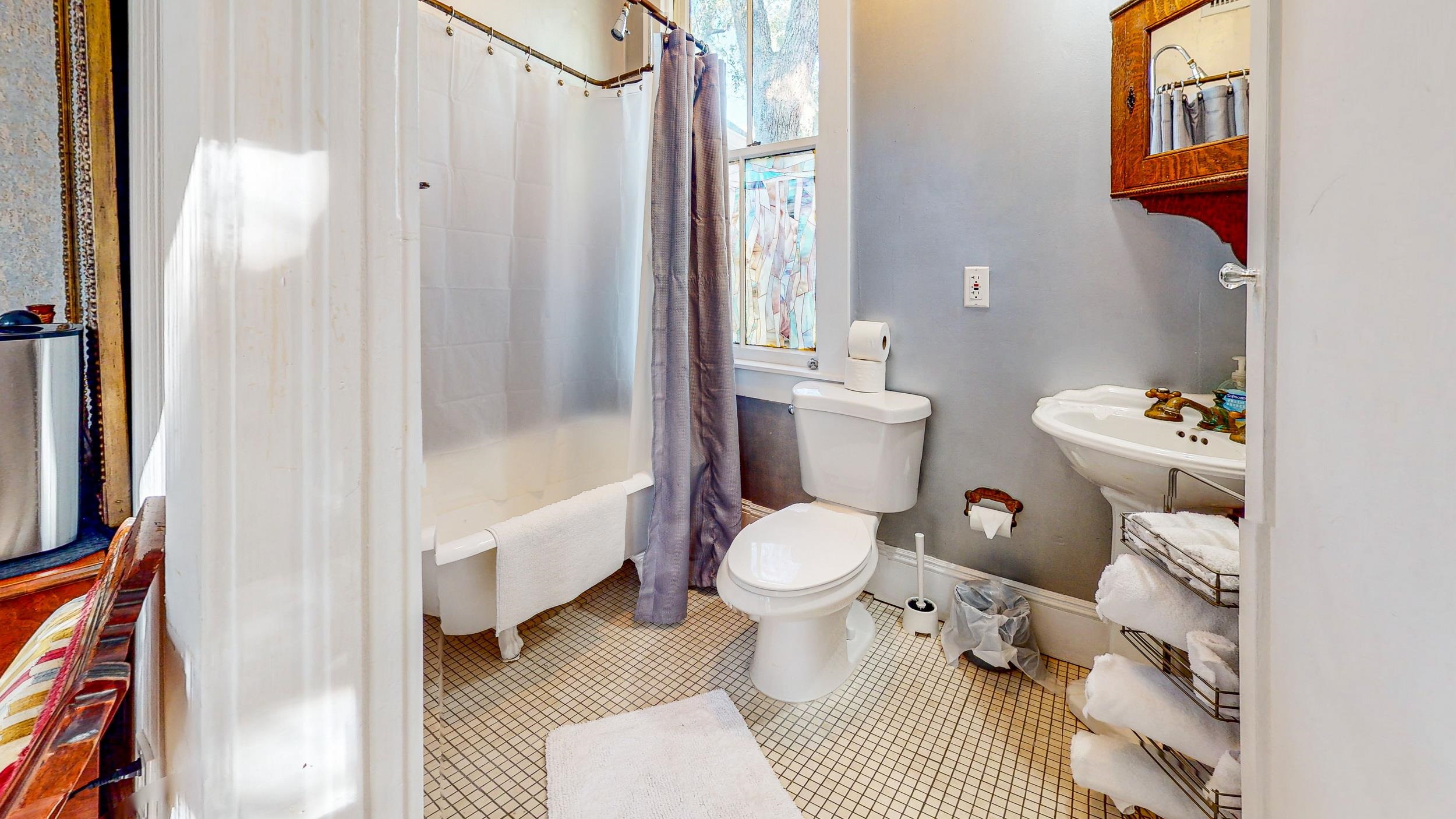 63 Orange Street St. Augustine, FL 32084 - Photo 48 of 74 a bathroom with a toilet and a shower curtain