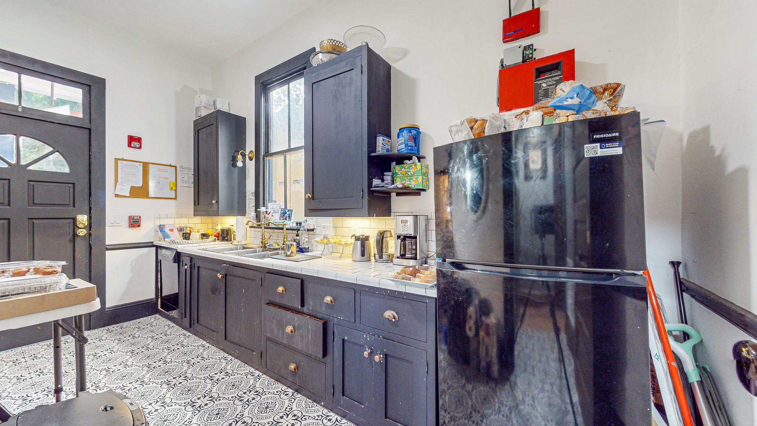 63 Orange Street St. Augustine, FL 32084 - Photo 60 of 74 a kitchen with stainless steel appliances granite countertop a refrigerator and a sink