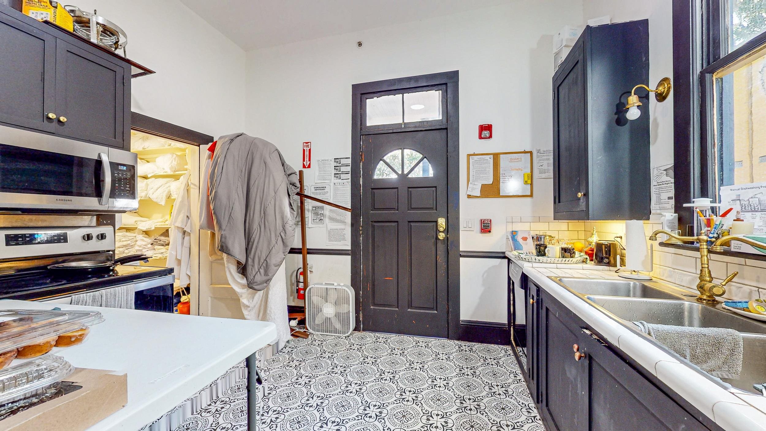 63 Orange Street St. Augustine, FL 32084 - Photo 61 of 74 a kitchen with stainless steel appliances granite countertop a refrigerator a stove top oven a sink and dishwasher