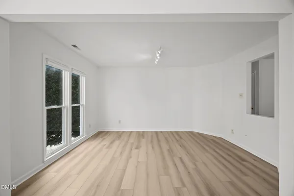 a view of a room with wooden floor and window