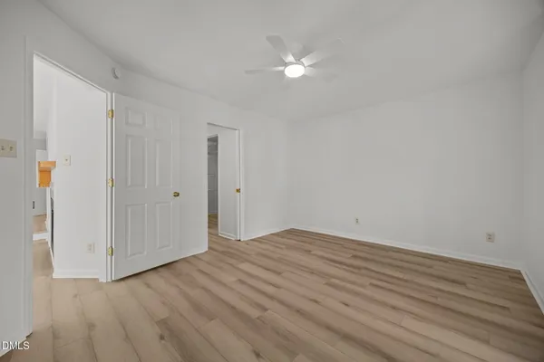 a view of an empty room with wooden floor