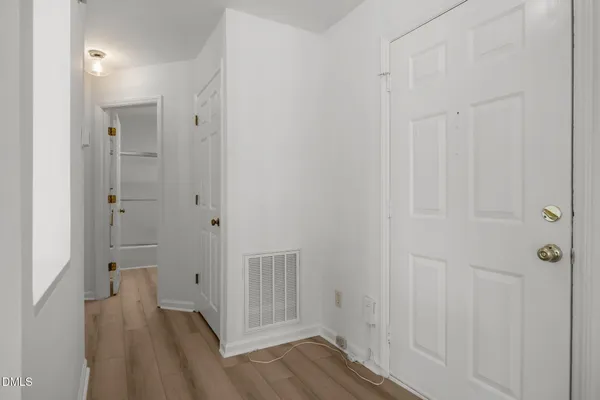 a view of a hallway with wooden floor