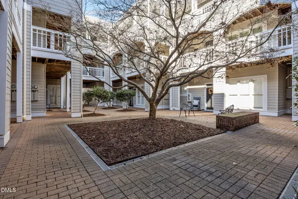 a view of a porch with a bench in front of building