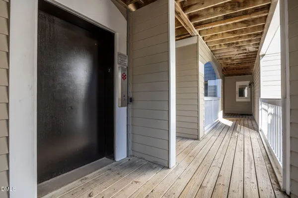 a view of a balcony with wooden floor and staircase