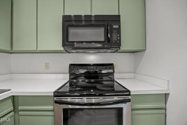 a stove top oven sitting inside of a kitchen