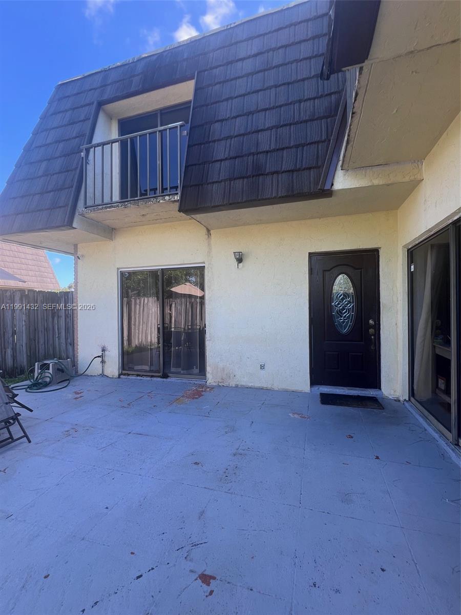 a view of an empty room with furniture and a fireplace