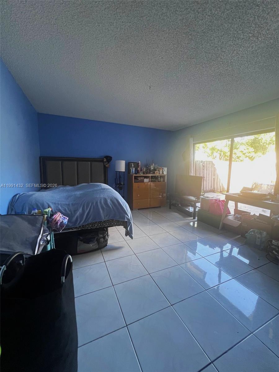 4681 Cherry Road West Palm Beach, FL 33417 - Photo 12 of 33 a bed room with a bed and a couch