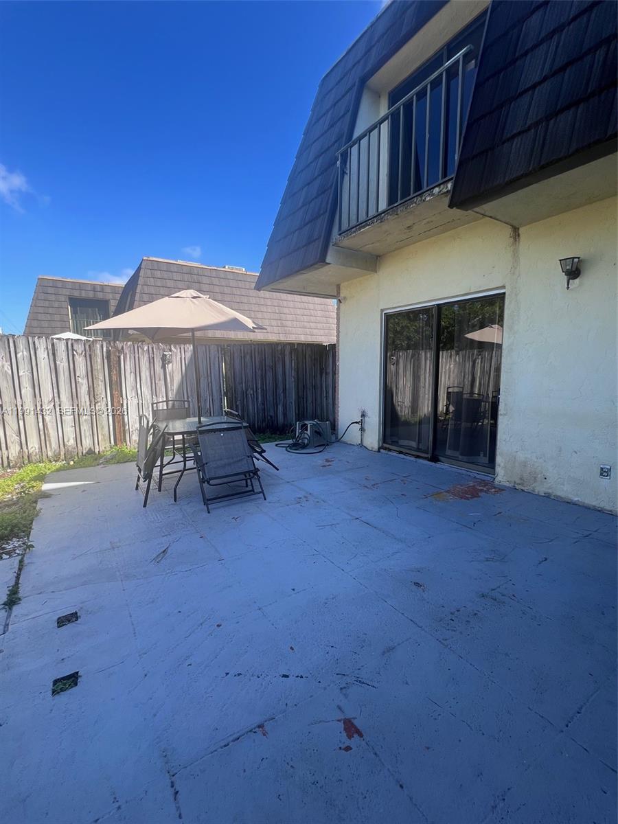 4681 Cherry Road West Palm Beach, FL 33417 - Photo 2 of 33 a view of a balcony with furniture and a yard