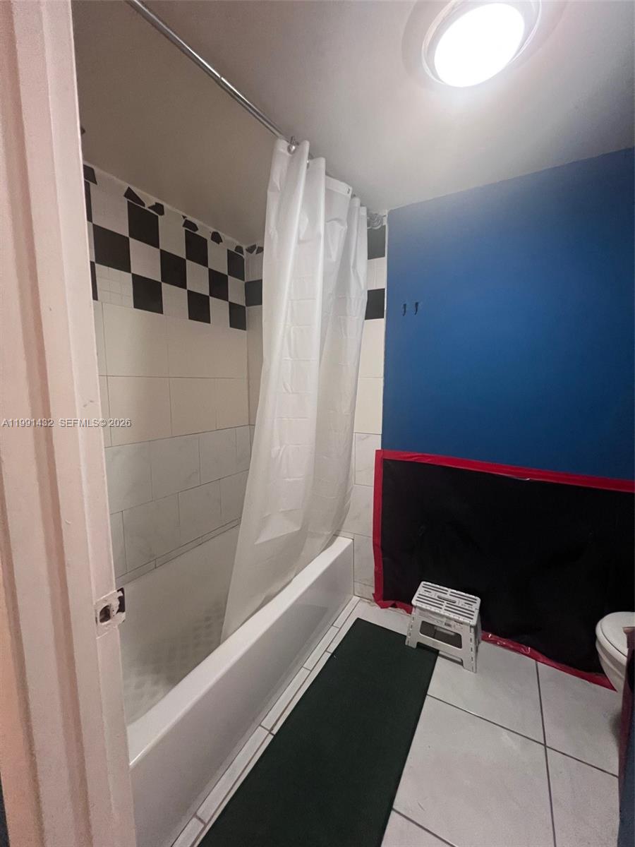 4681 Cherry Road West Palm Beach, FL 33417 - Photo 30 of 33 a bathroom with a bathtub and a shower