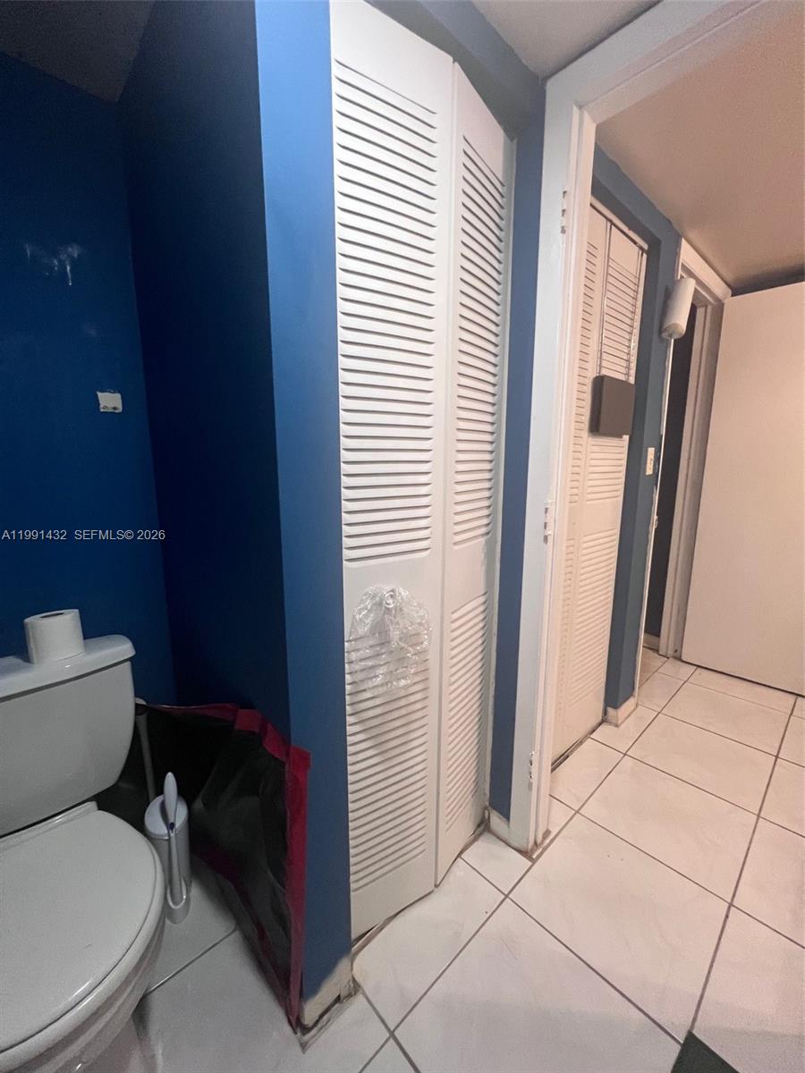 4681 Cherry Road West Palm Beach, FL 33417 - Photo 31 of 33 a white toilet sitting in a bathroom next to a window