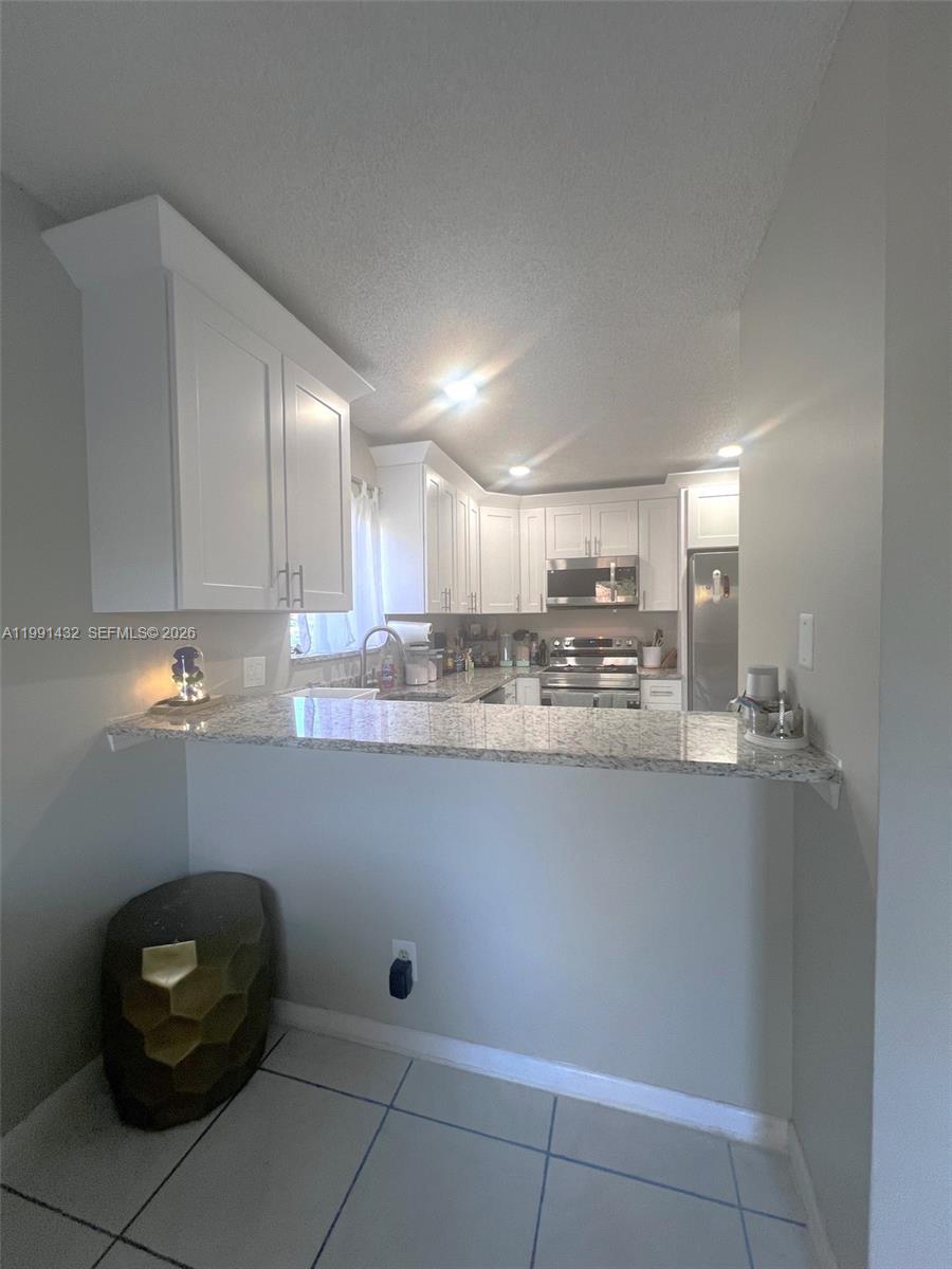 4681 Cherry Road West Palm Beach, FL 33417 - Photo 7 of 33 a kitchen with a sink and cabinets