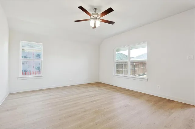 an empty room with fan and a ceiling fan