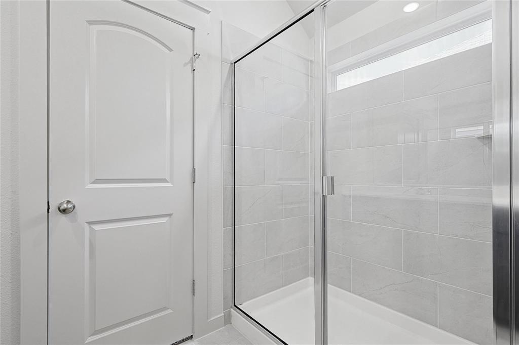 1759 Gleasondale Place Forney, TX 75126 - Photo 13 of 25 a bathroom with a glass shower door