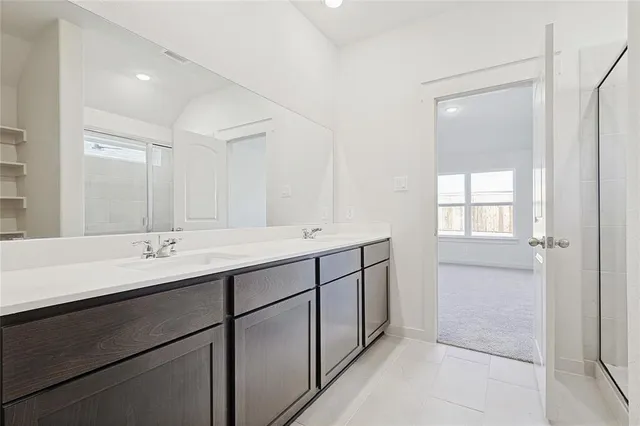 a bathroom with a glass shower door