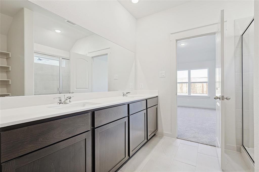 1759 Gleasondale Place Forney, TX 75126 - Photo 15 of 25 a bathroom with a double vanity sink and a mirror