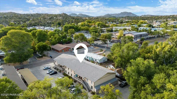 an aerial view of a house with a yard