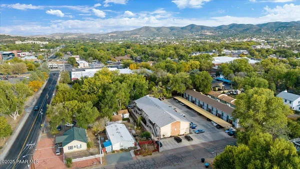 an aerial view of residential houses with outdoor space and street view