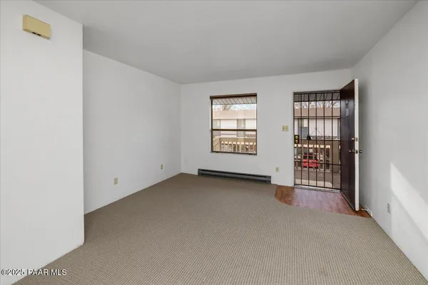 an empty room with closet and cabinet