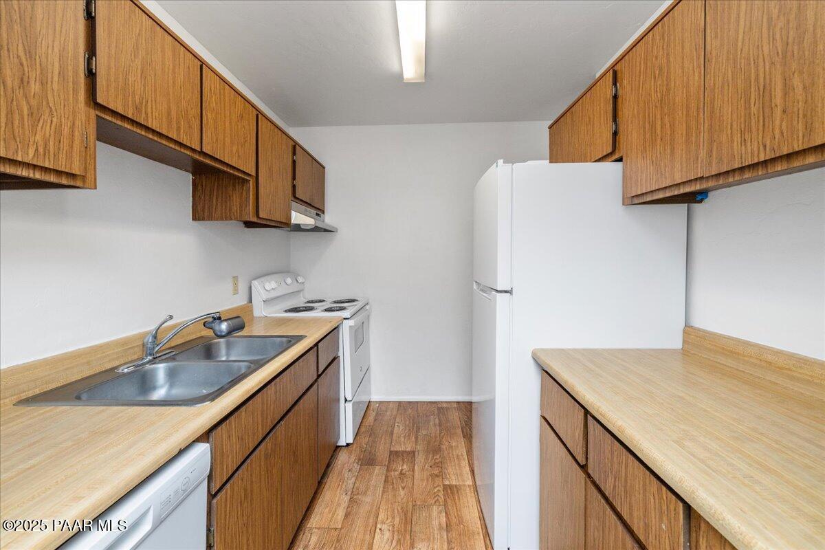 849 Sunset Avenue Prescott, AZ 86305 - Photo 25 of 30 a kitchen with stainless steel appliances granite countertop a sink and a refrigerator