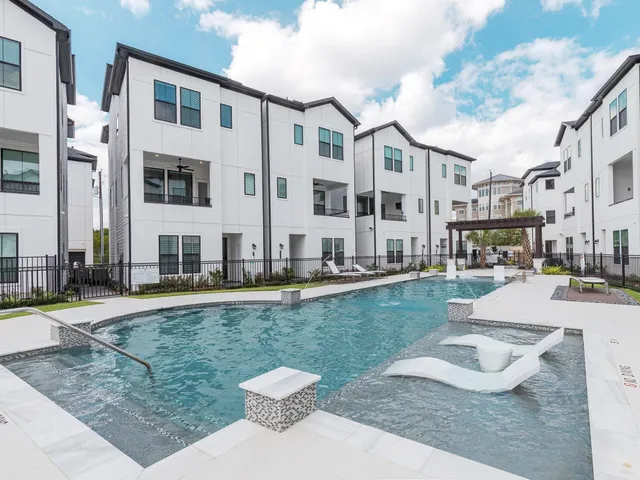a view of a house with a swimming pool and a yard