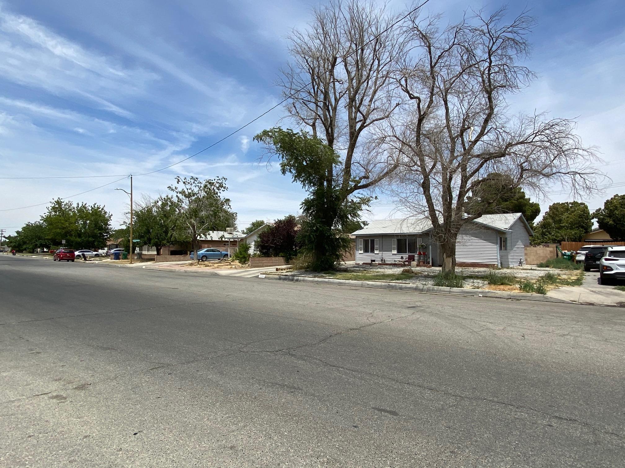 44290 Glenraven Road Lancaster, CA 93535 - Photo 3 of 4 a view of a street with a cars parked on the road