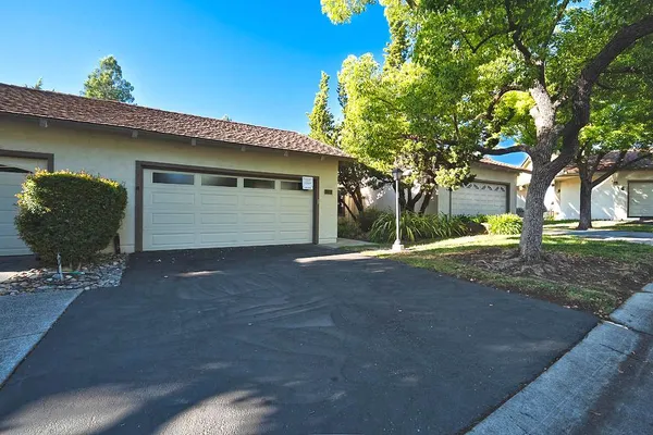 a view of a house with a yard and garage