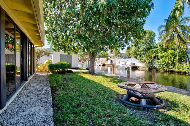 a swimming pool with outdoor seating and plants