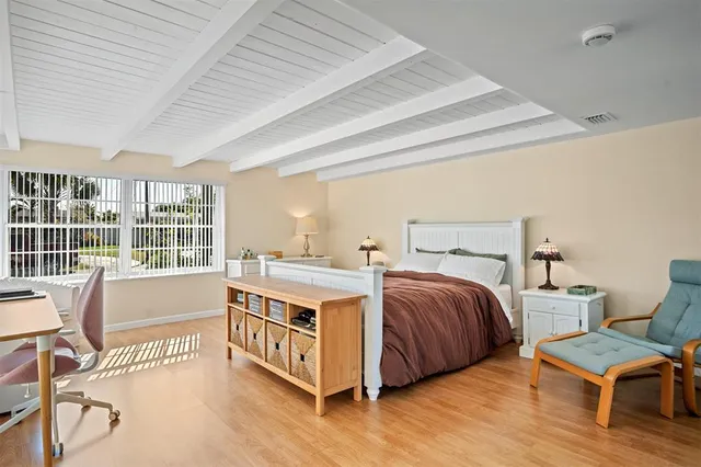 a spacious bedroom with a bed and a large window