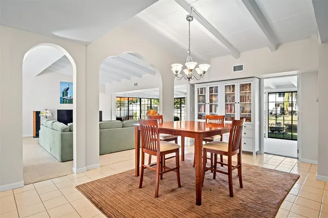 a view of a dining room with furniture and chandelier
