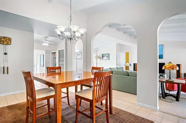 a view of a dining room with furniture and a chandelier