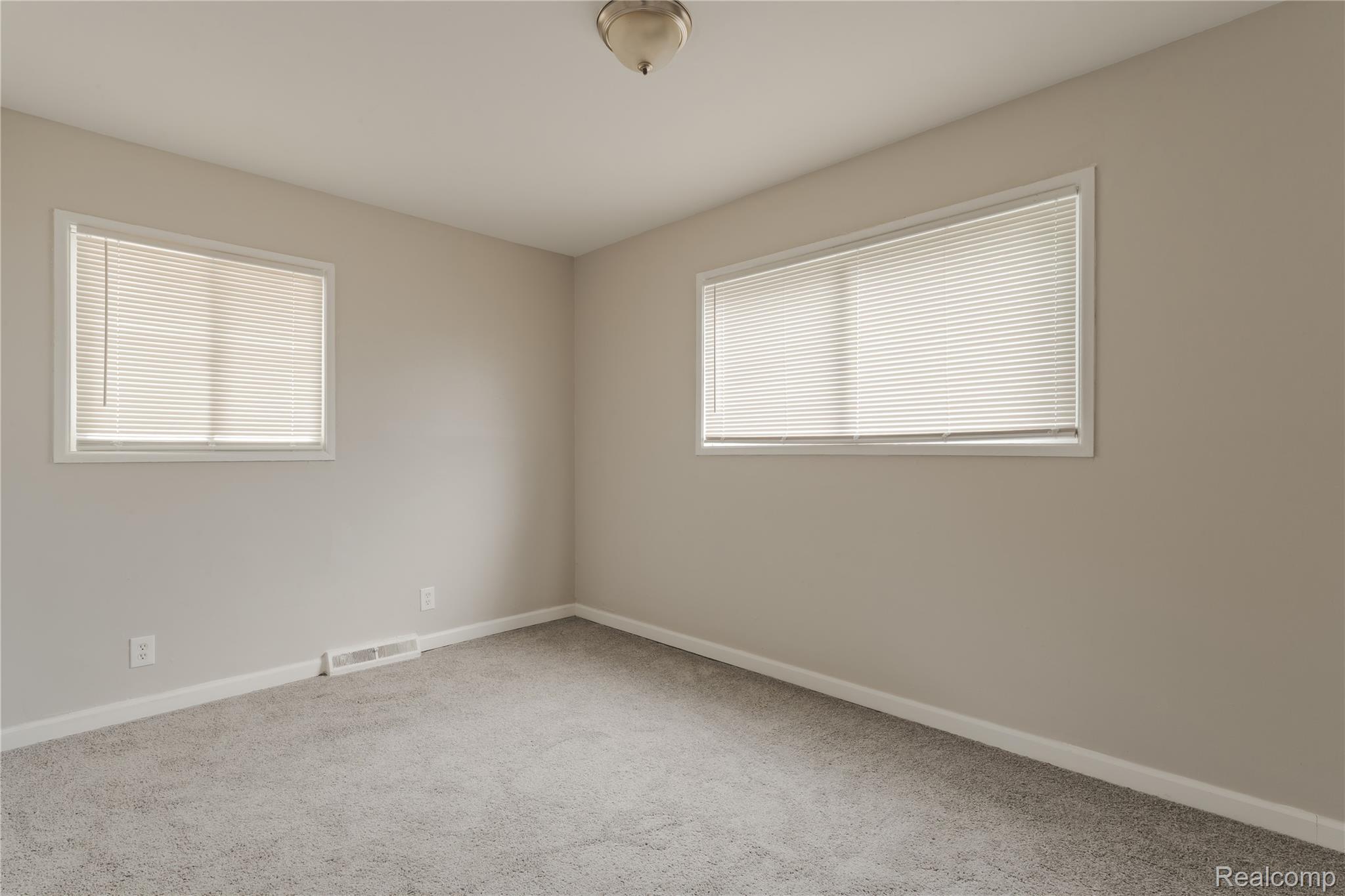 93 West Princeton Avenue Pontiac, MI 48340 - Photo 7 of 31 Neutral-toned walls complement the gray carpeting