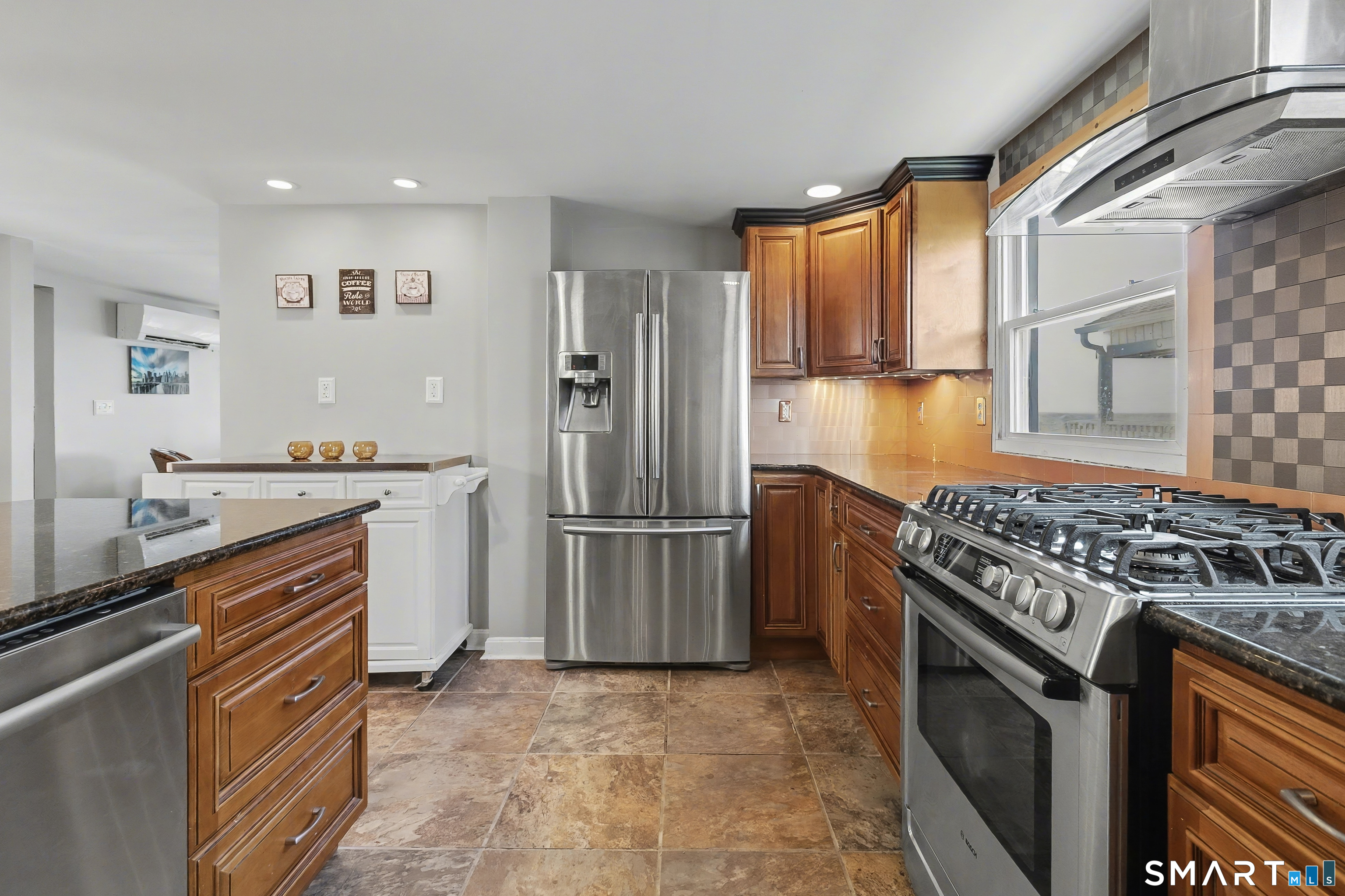51 Point Beach Drive Milford, CT 06460 - Photo 14 of 32 a kitchen with stainless steel appliances granite countertop a stove a refrigerator and a sink