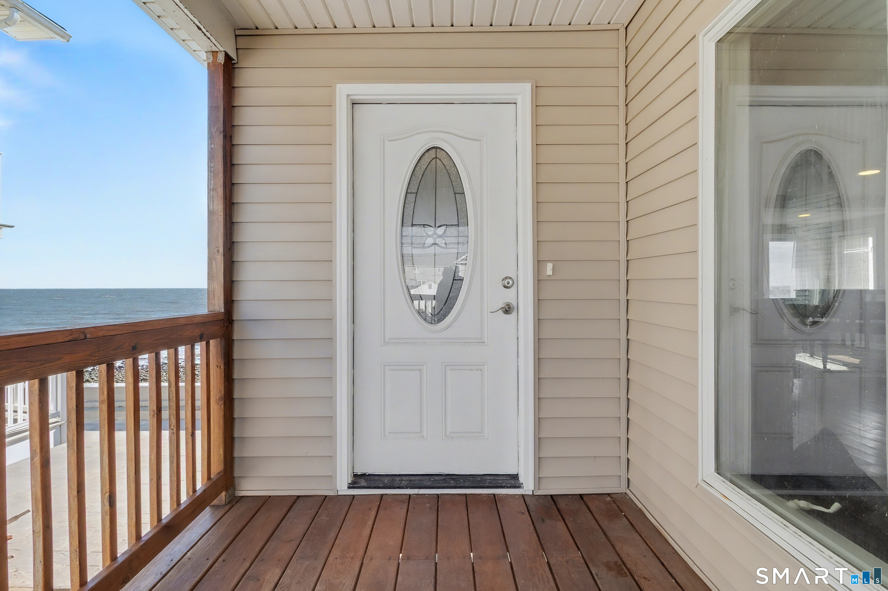 51 Point Beach Drive Milford, CT 06460 - Photo 5 of 32 a view of a livingroom with wooden floor and entrance