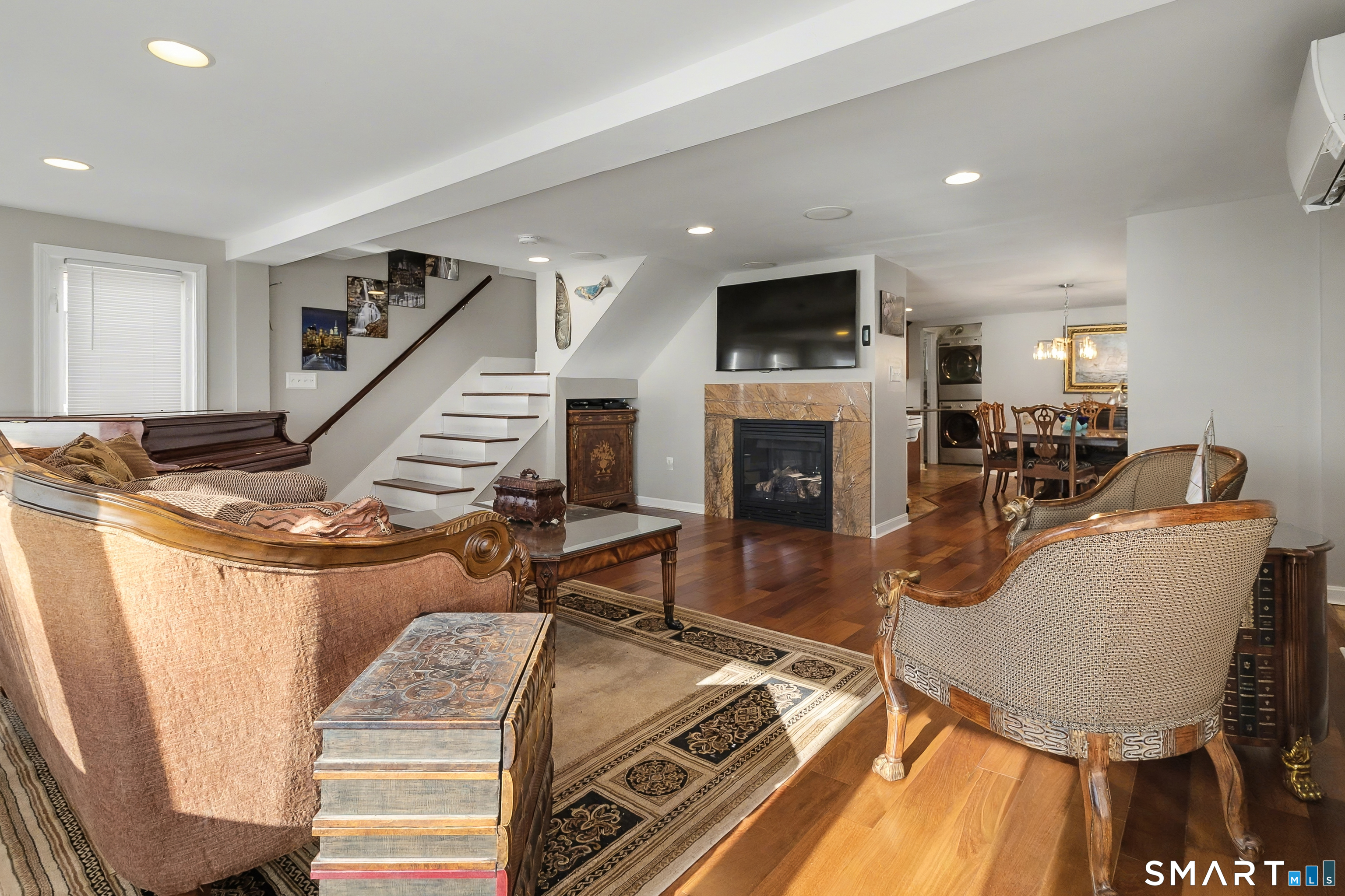 51 Point Beach Drive Milford, CT 06460 - Photo 10 of 32 a living room with furniture a fireplace and a flat screen tv