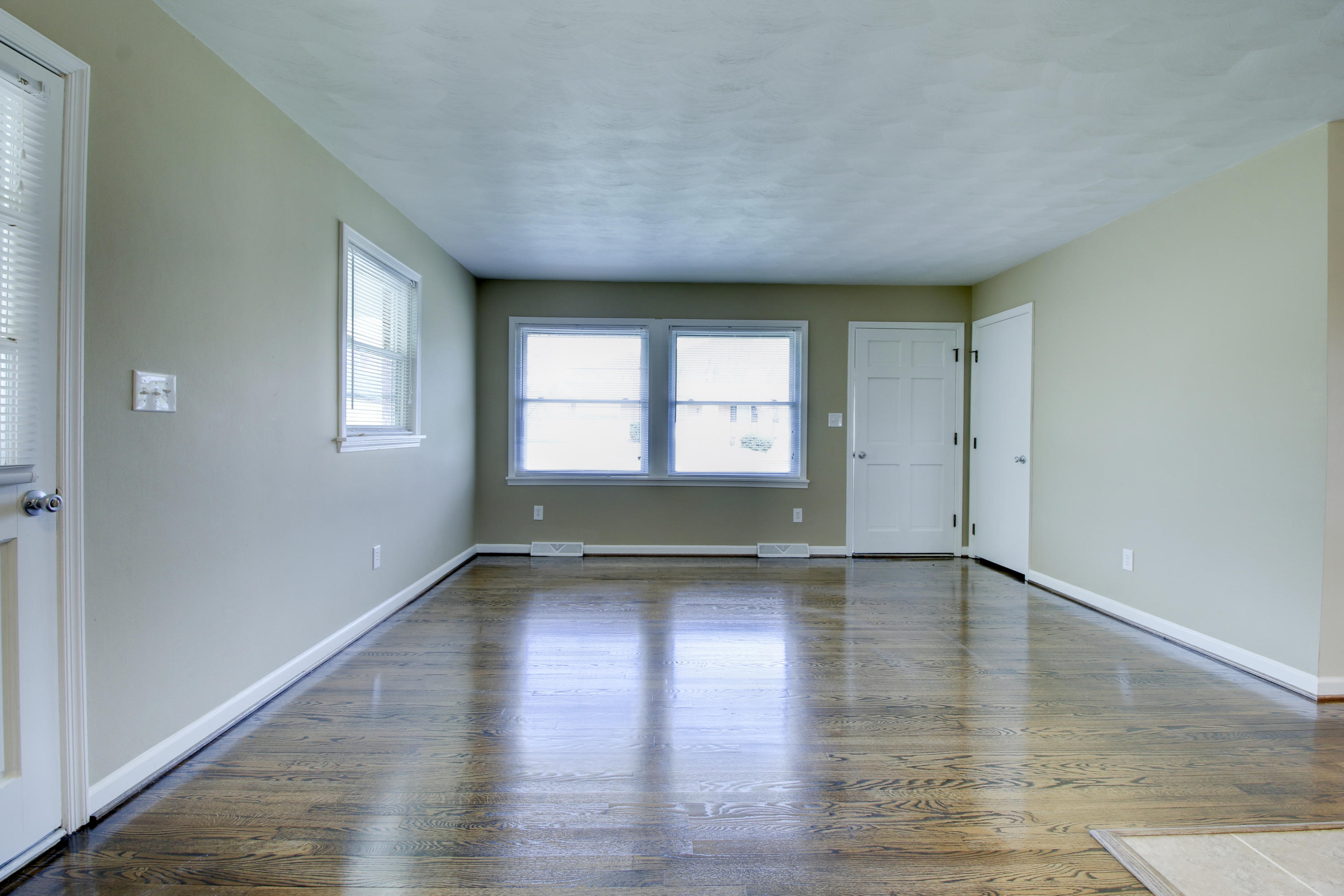 540 Olney Road Vinton, VA 24179 - Photo 8 of 29 an empty room with wooden floor and windows