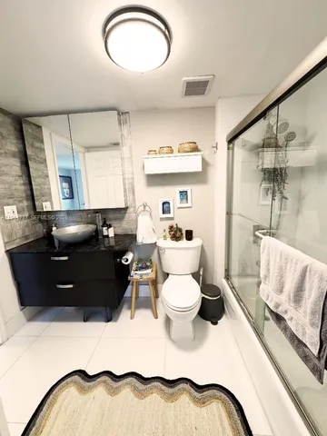 a living room with a couch and a potted plant