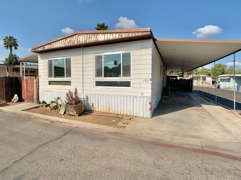 400 Greenfield Drive, Unit 150 El Cajon, CA 92021 - Photo 2 of 21 a view of a house with a patio and a yard