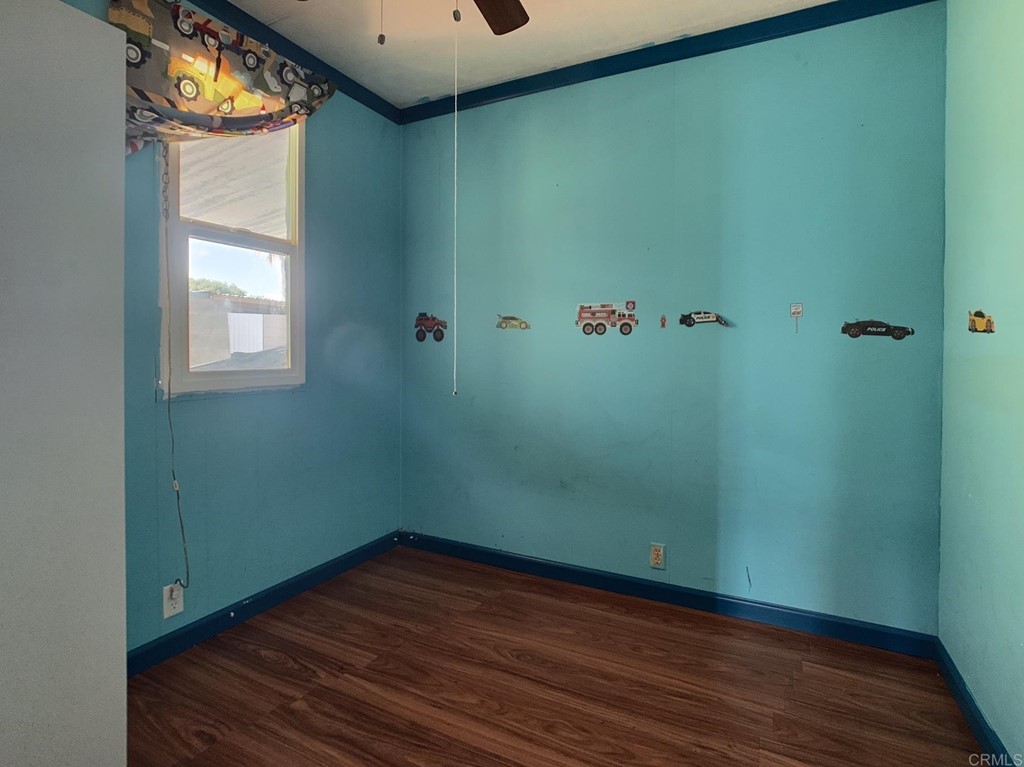 400 Greenfield Drive, Unit 150 El Cajon, CA 92021 - Photo 15 of 21 a view of an empty room with wooden floor and a window