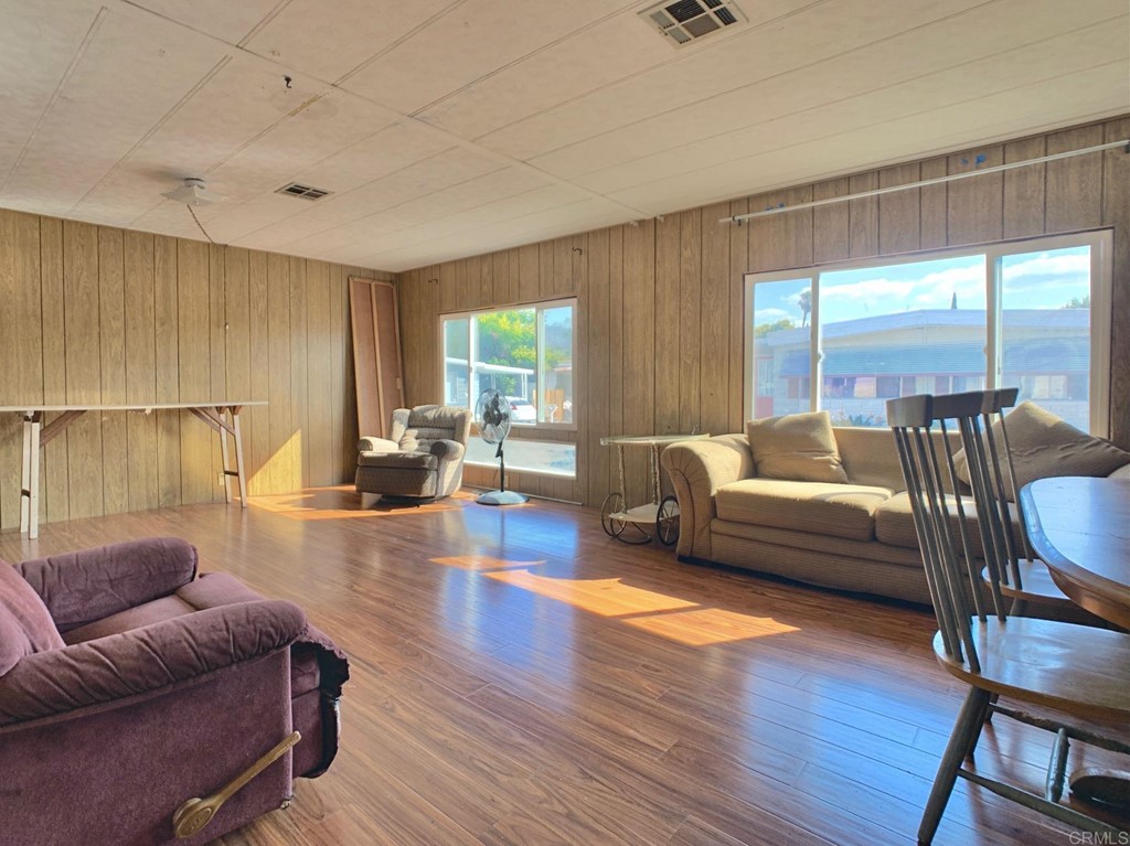 400 Greenfield Drive, Unit 150 El Cajon, CA 92021 - Photo 5 of 21 a living room with furniture and wooden floor