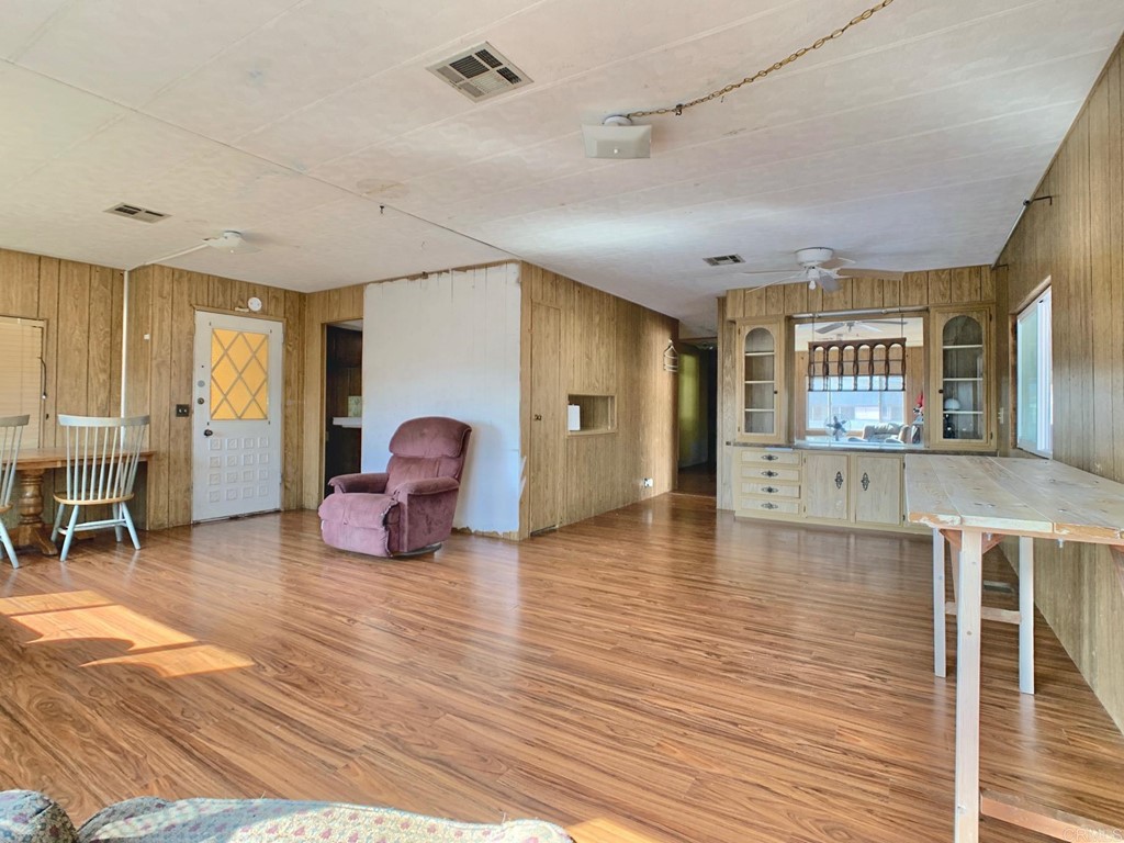 400 Greenfield Drive, Unit 150 El Cajon, CA 92021 - Photo 6 of 21 a living room with furniture and wooden floor